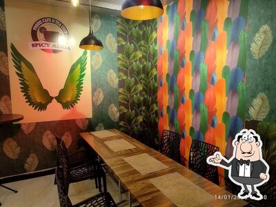 Take a seat at one of the tables at Spicy Adda