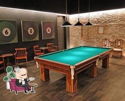 Sente em uma das mesas no Sinucão do Anselmo